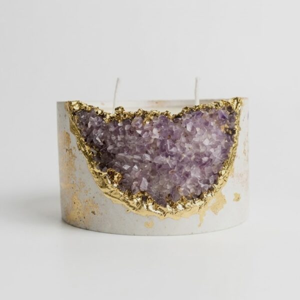 Handmade ivory Jesmonite candle bowl with amethyst crystal geode and gold leaf edge on travertine table